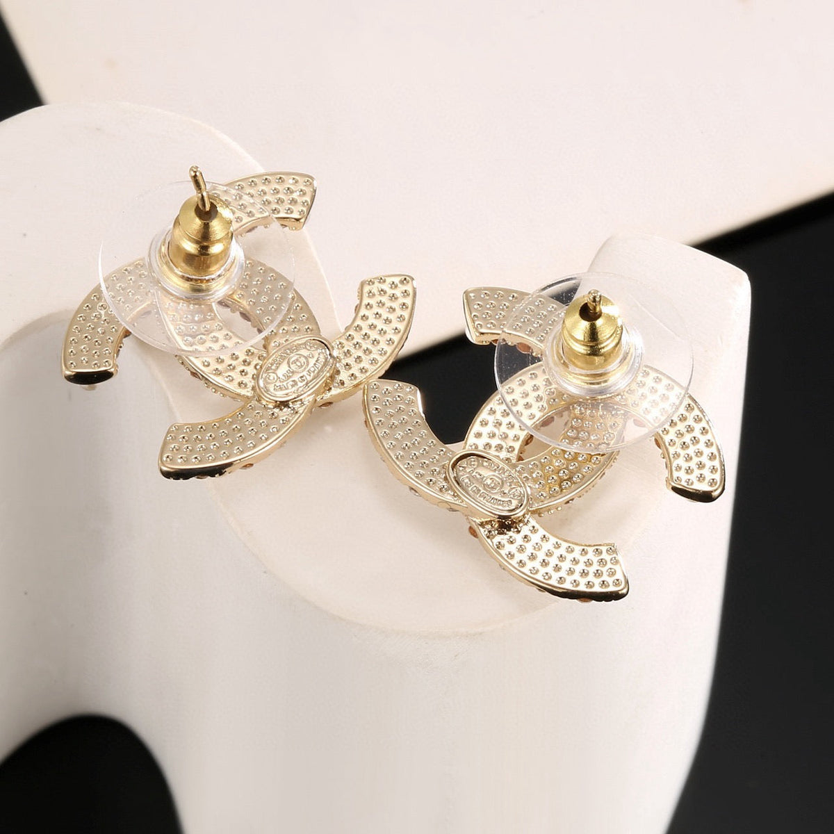 Martin Graham stud earrings in polished metal-tone – side detail