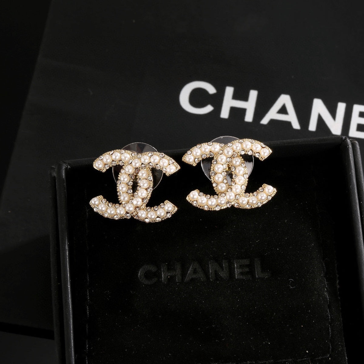 Martin Graham stud earrings in polished metal-tone – close-up detail