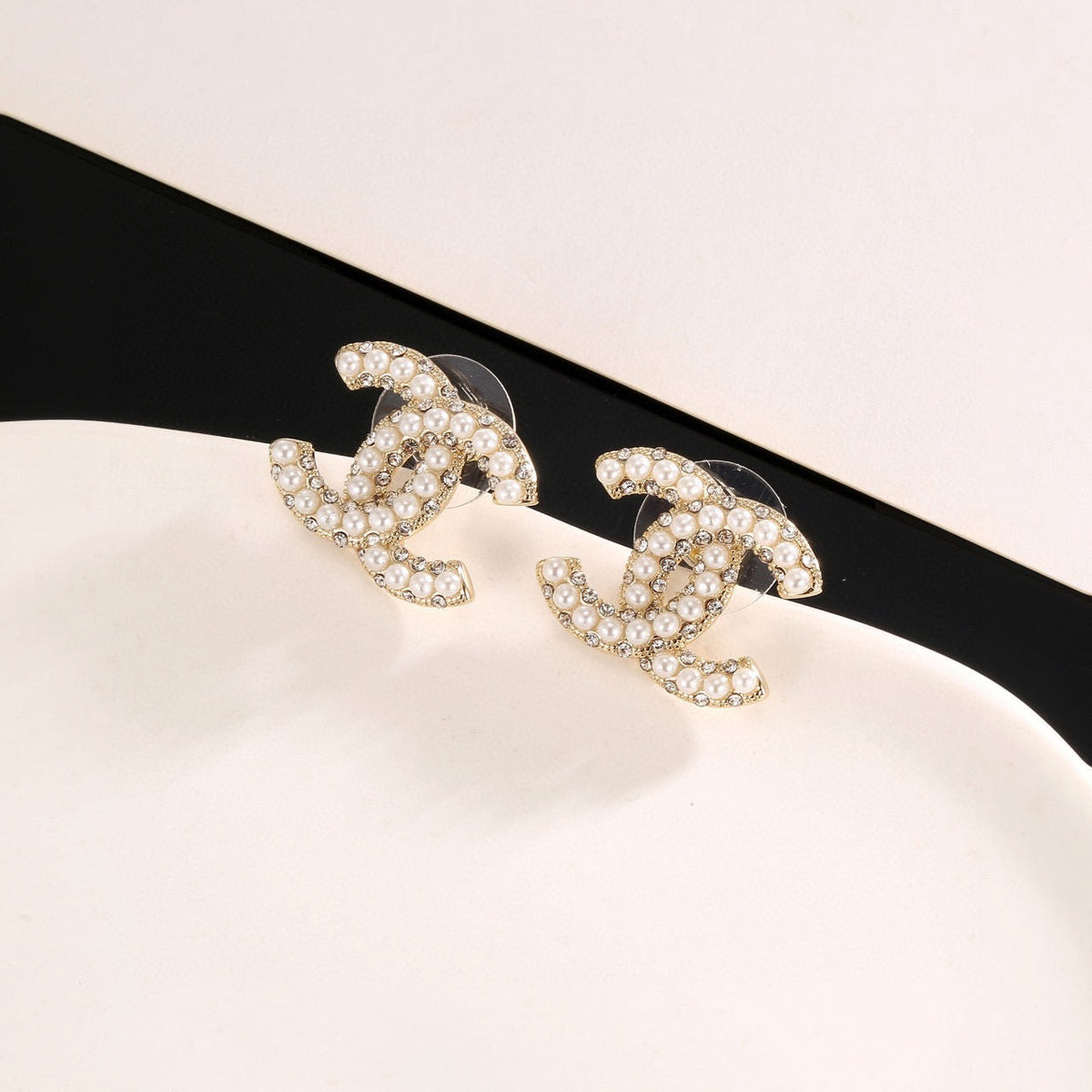 Martin Graham stud earrings in polished metal-tone – styled product view