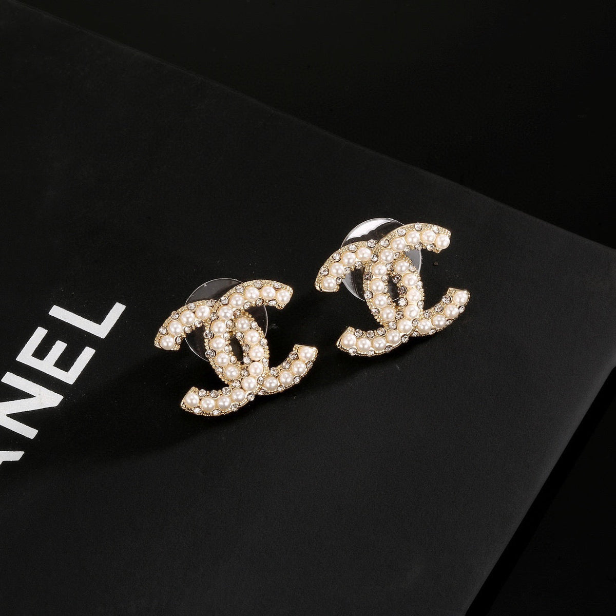 Martin Graham stud earrings in polished metal-tone – detail view
