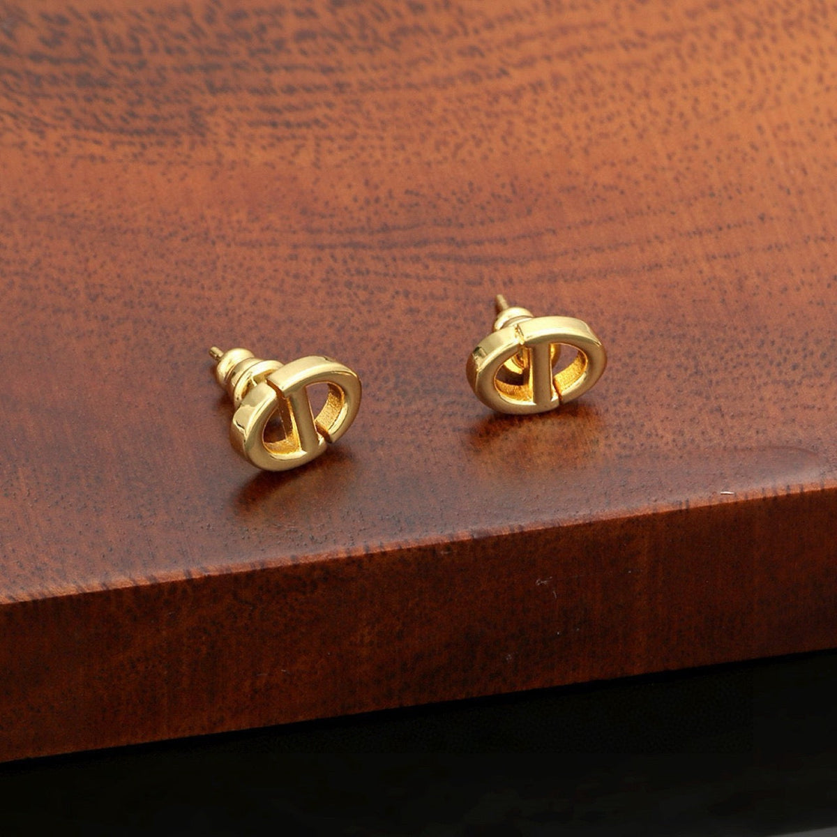 Martin Graham stud earrings in polished metal-tone – detail view