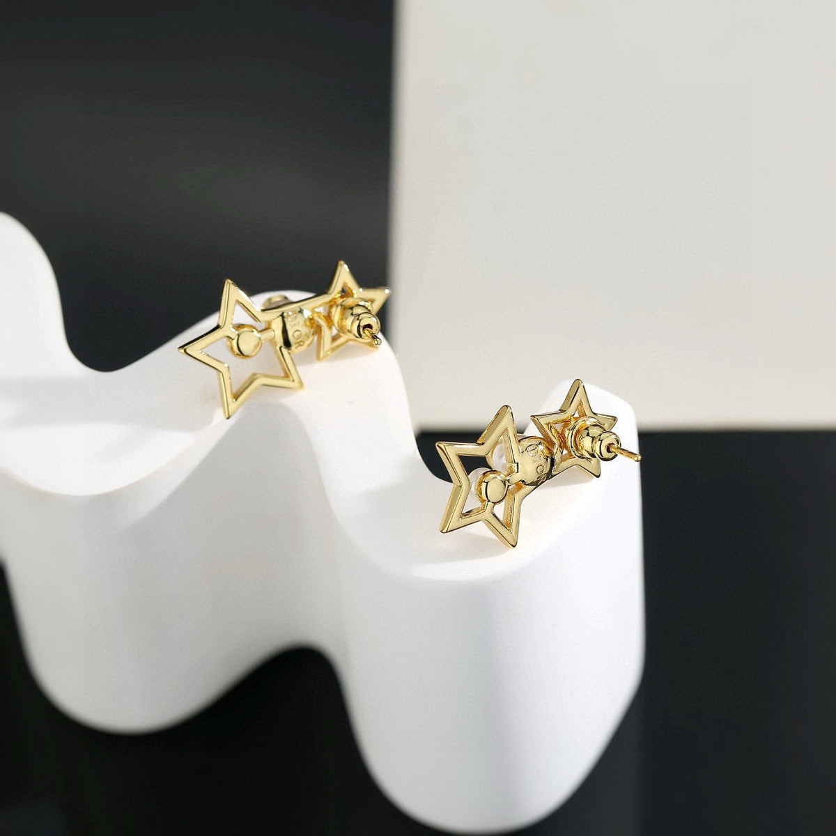 Martin Graham stud earrings in polished metal-tone – close-up detail