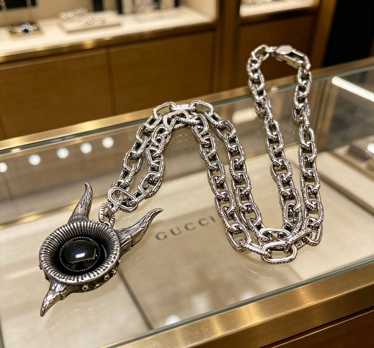 Martin Graham pendant necklace in polished metal-tone – close-up detail