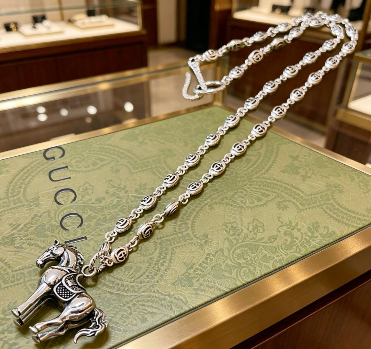 Martin Graham pendant necklace in polished metal-tone – close-up detail