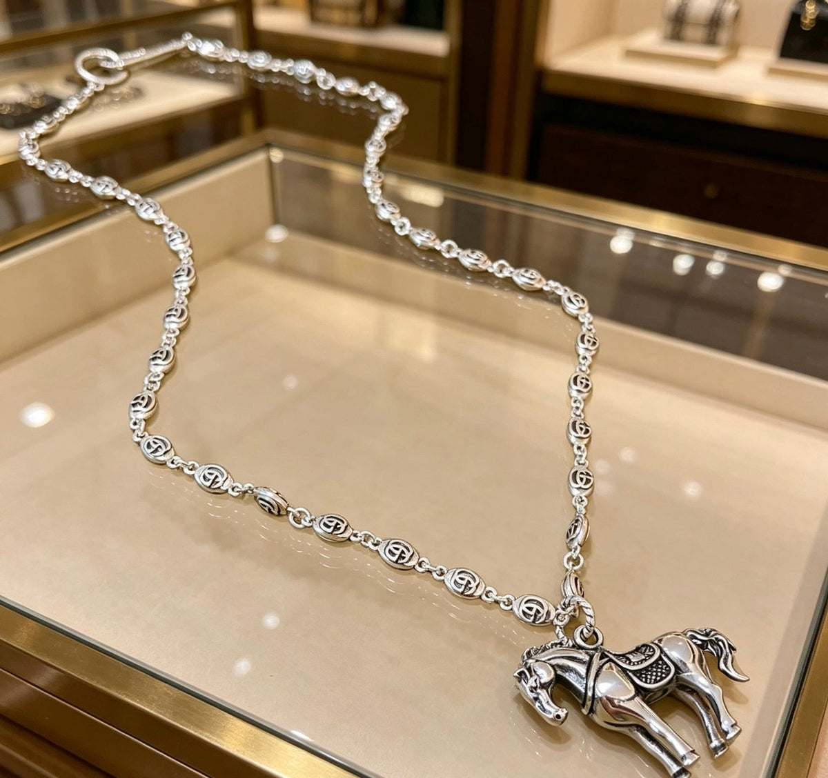 Martin Graham pendant necklace in polished metal-tone – side detail