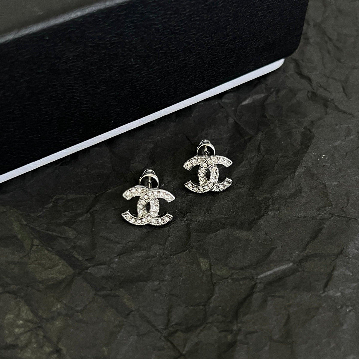 Martin Graham stud earrings in polished metal-tone – side detail