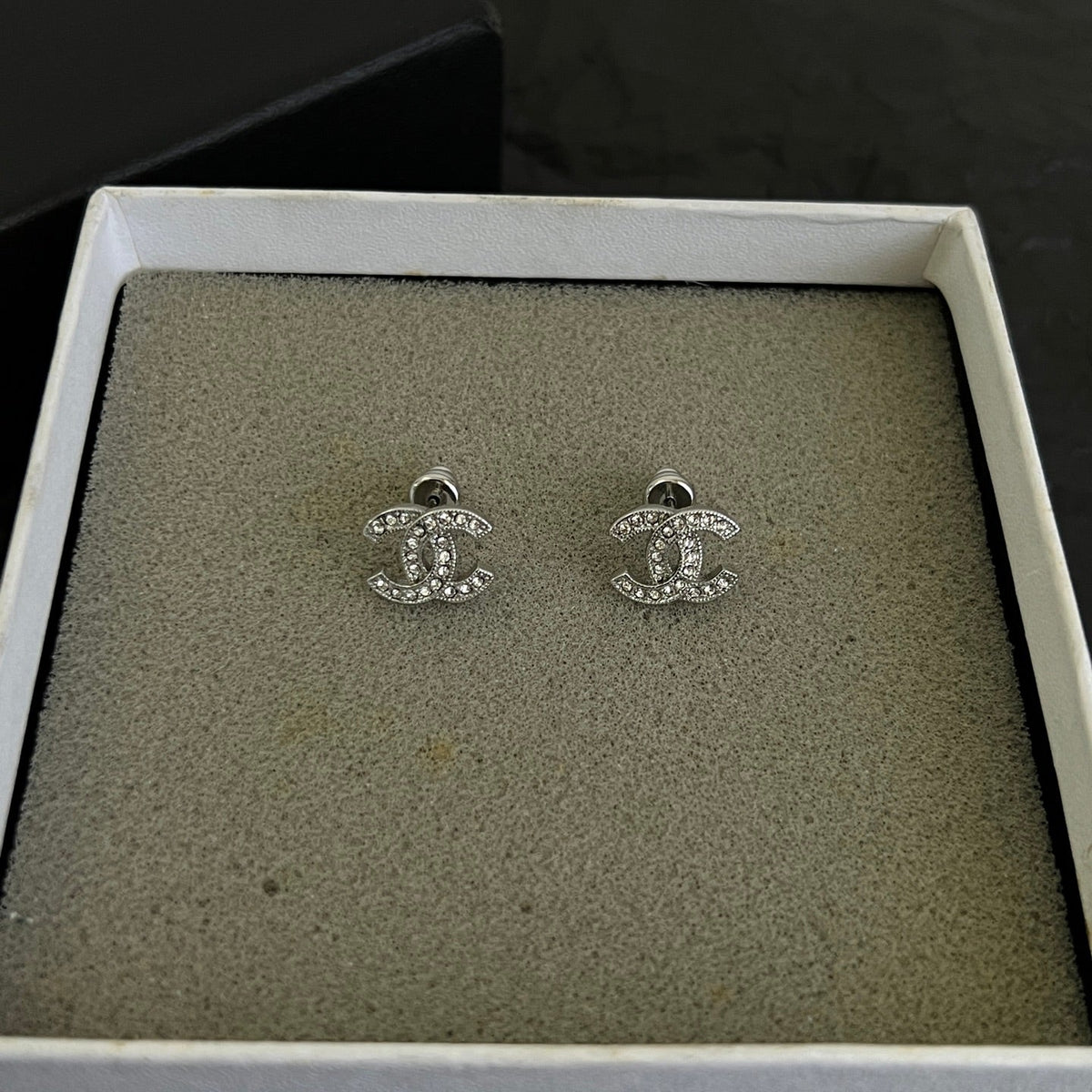 Martin Graham stud earrings in polished metal-tone – close-up detail