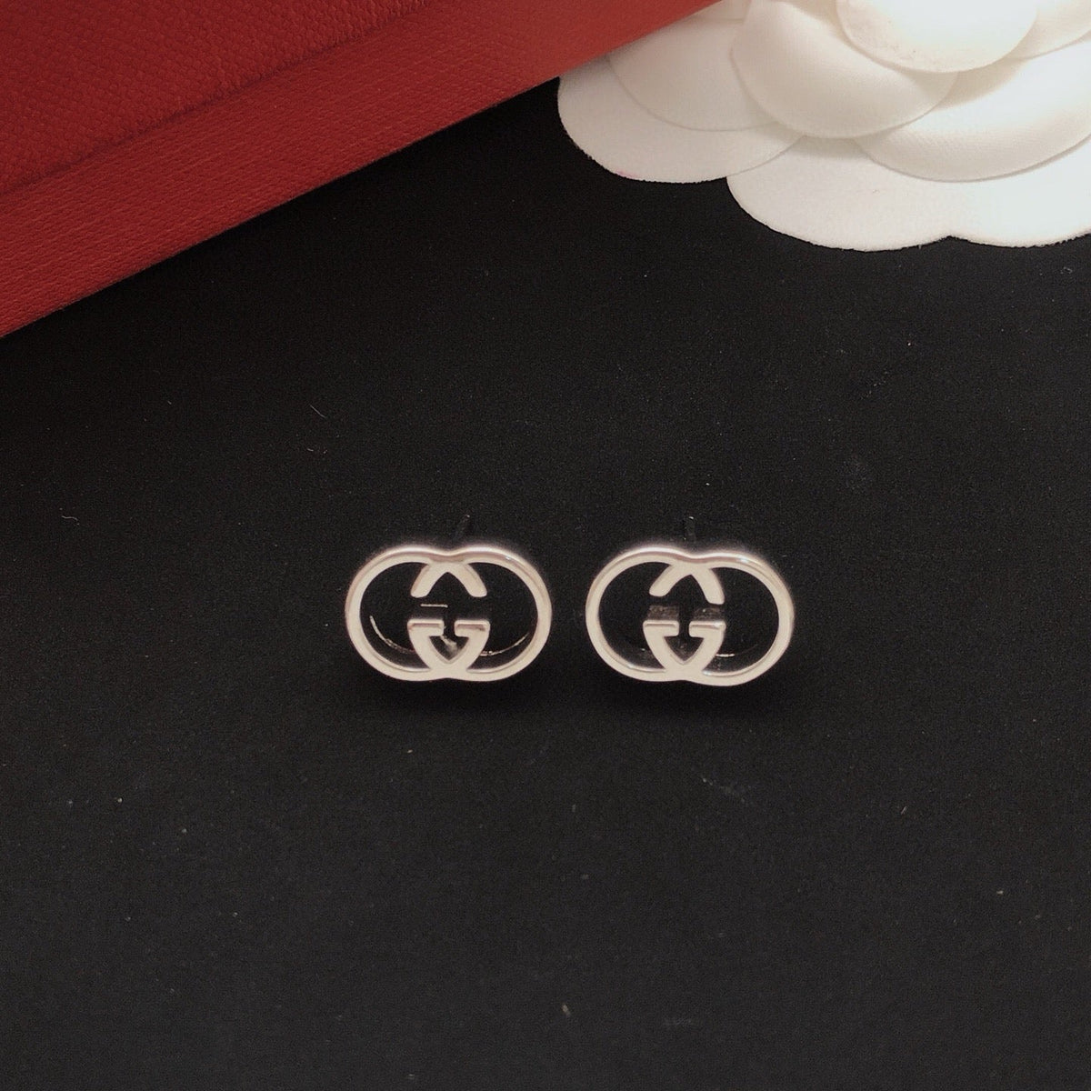 Martin Graham stud earrings in polished metal-tone – close-up detail