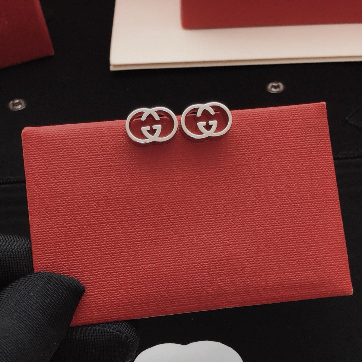 Martin Graham stud earrings in polished metal-tone – front product view
