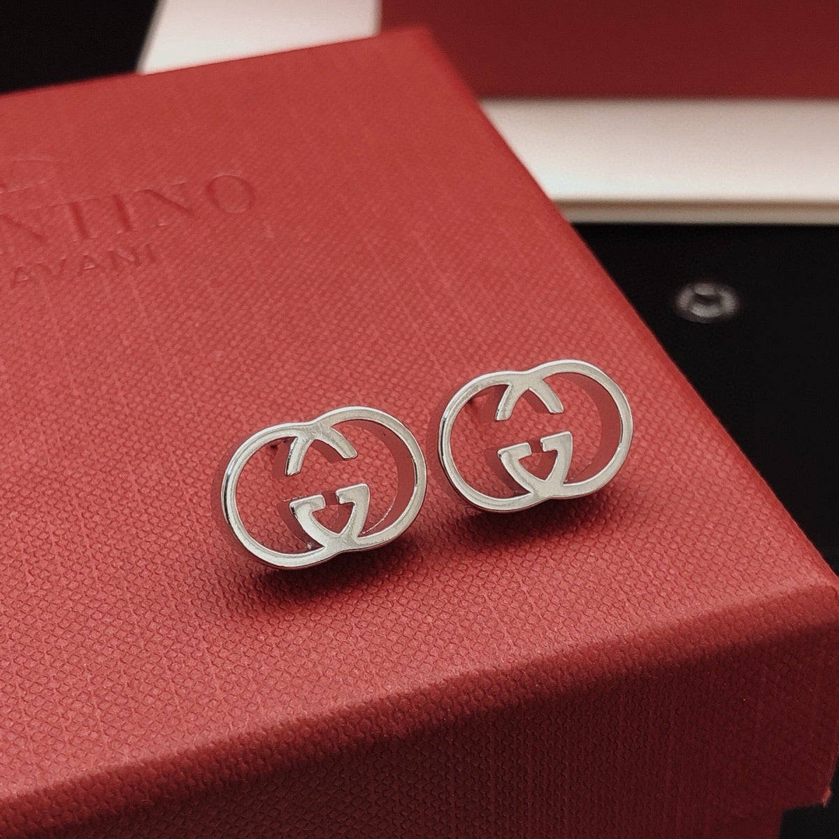 Martin Graham stud earrings in polished metal-tone – styled product view
