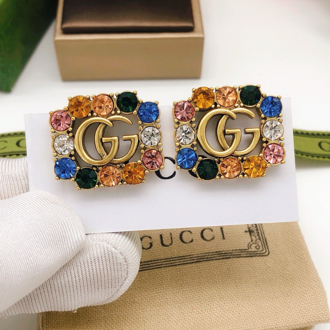 Martin Graham stud earrings in polished metal-tone – close-up detail