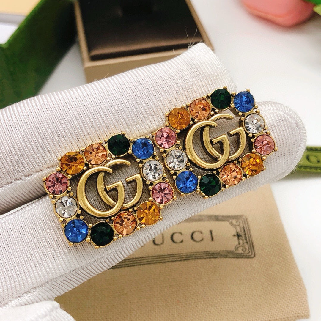 Martin Graham stud earrings in polished metal-tone – styled product view