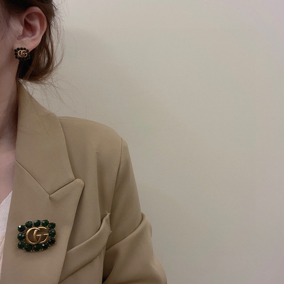 Martin Graham stud earrings in polished metal-tone – front product view