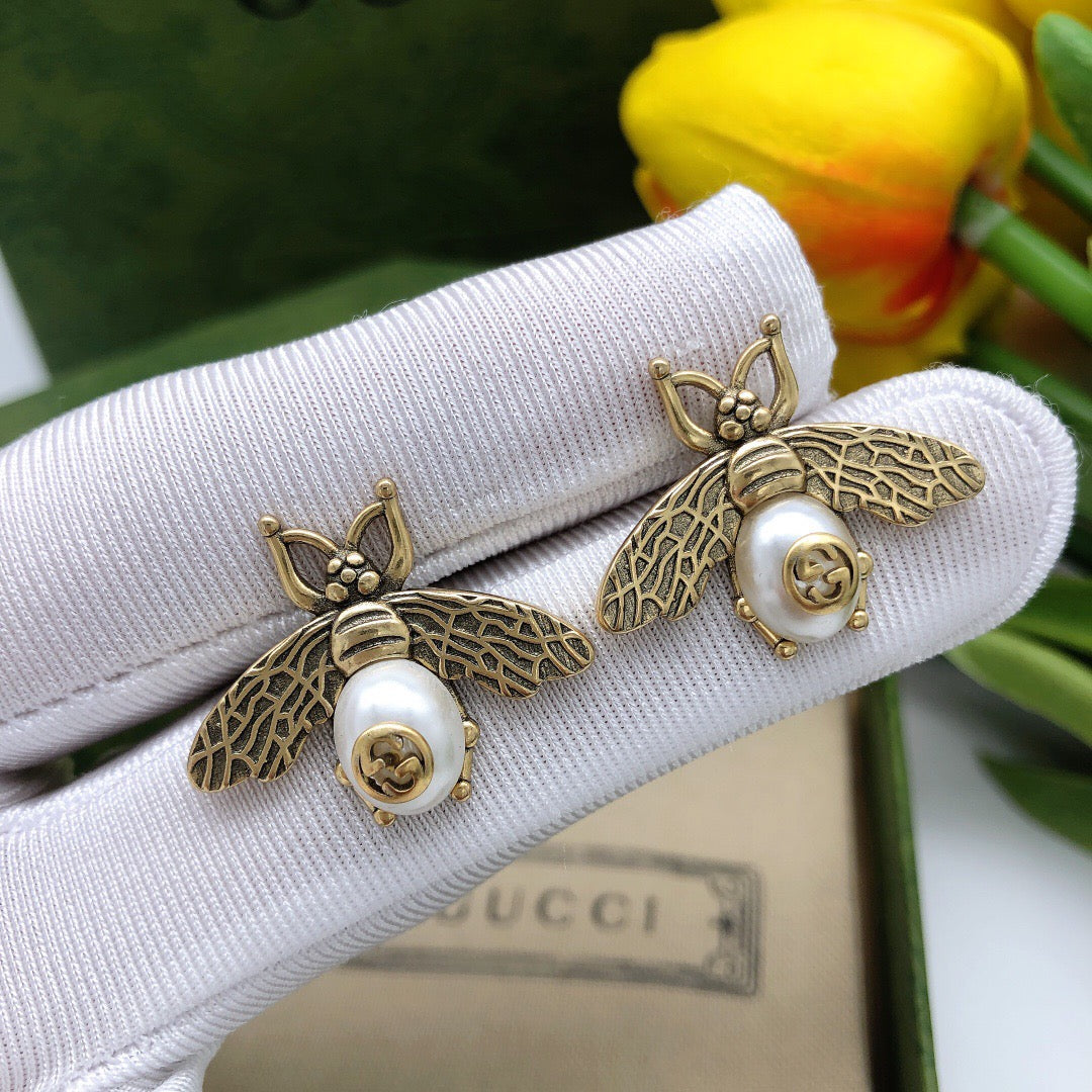 Martin Graham stud earrings in polished metal-tone – detail view