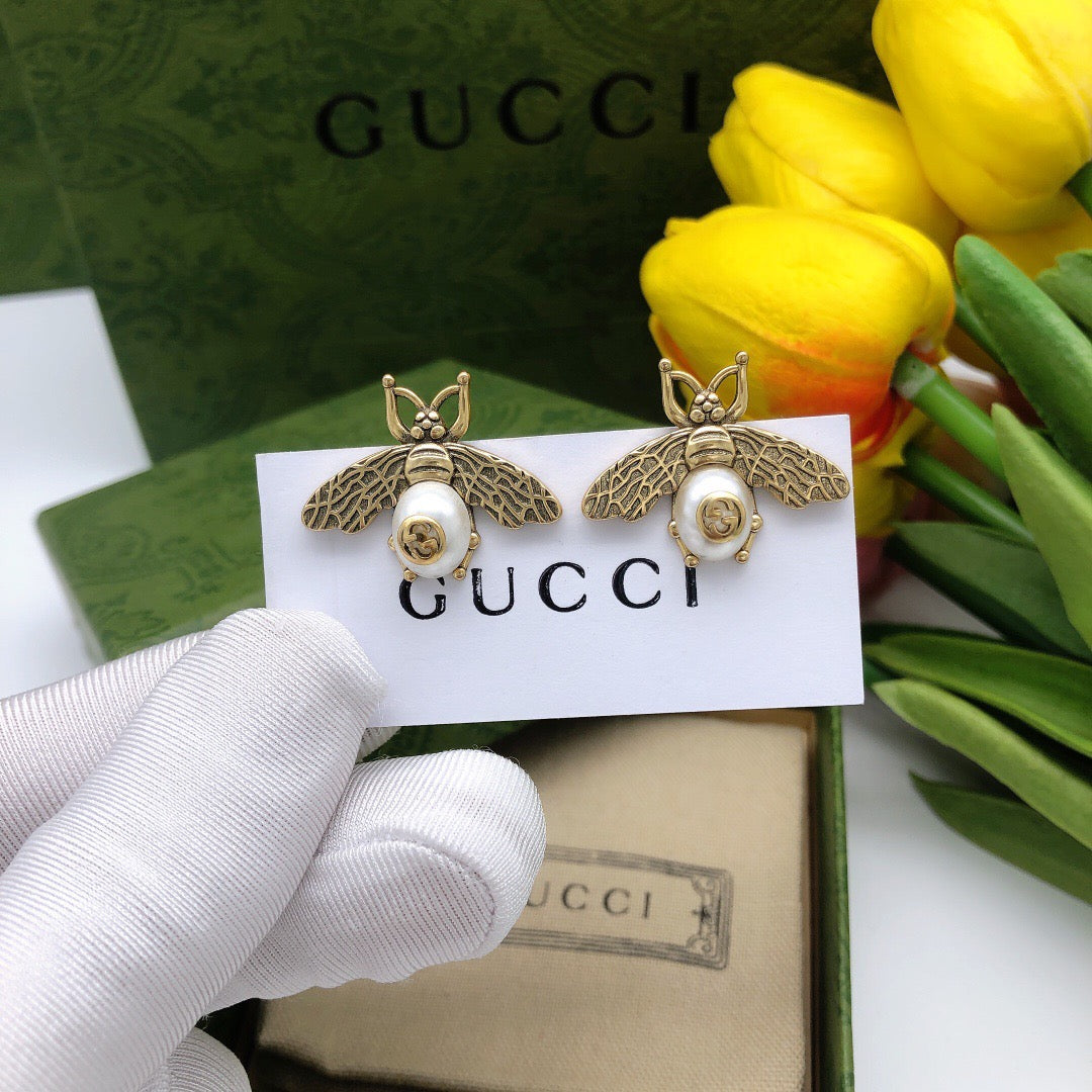 Martin Graham stud earrings in polished metal-tone – front product view