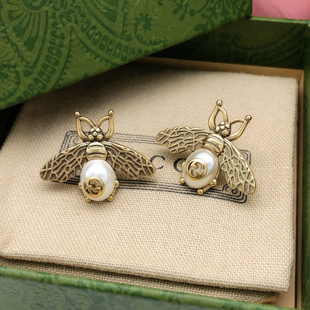 Martin Graham stud earrings in polished metal-tone – side detail