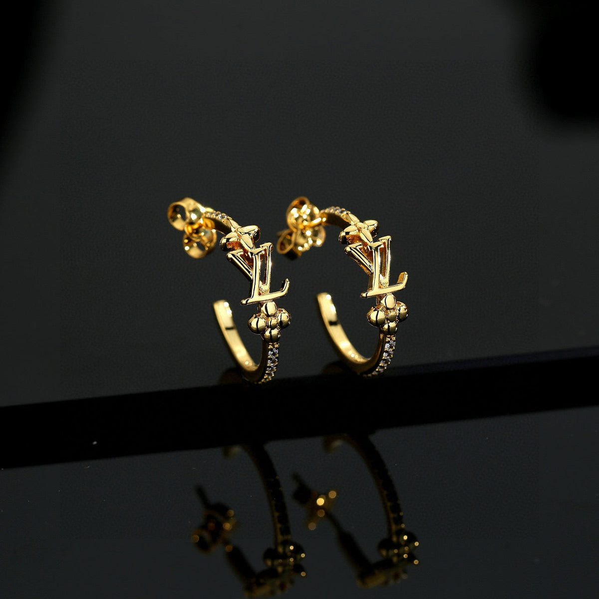 Martin Graham stud earrings in polished metal-tone – front product view