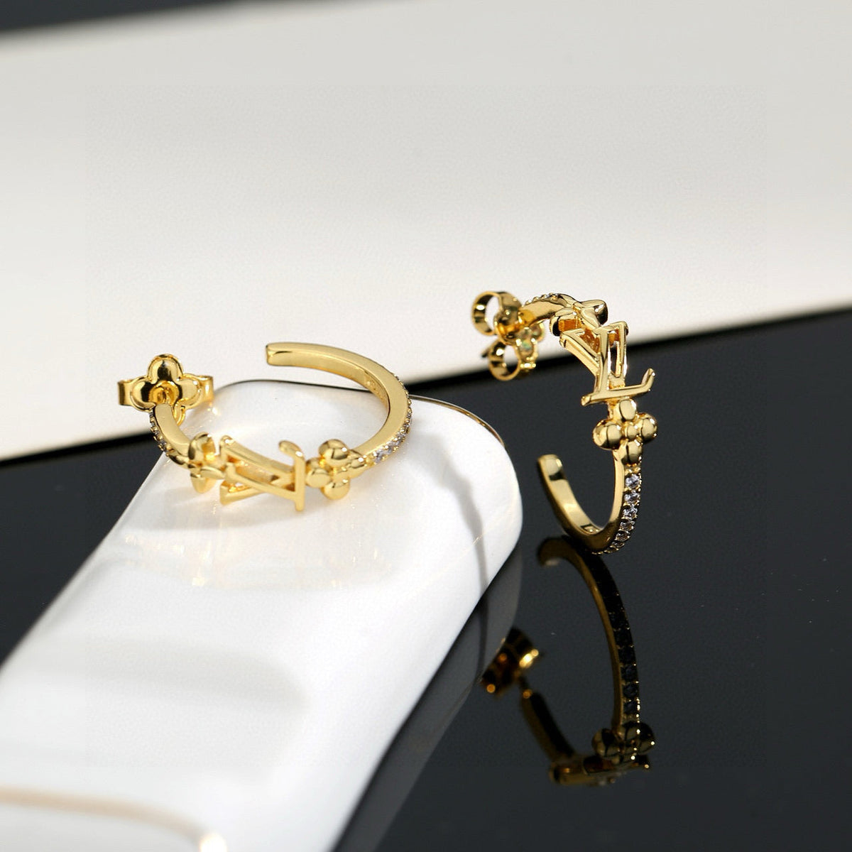 Martin Graham stud earrings in polished metal-tone – close-up detail