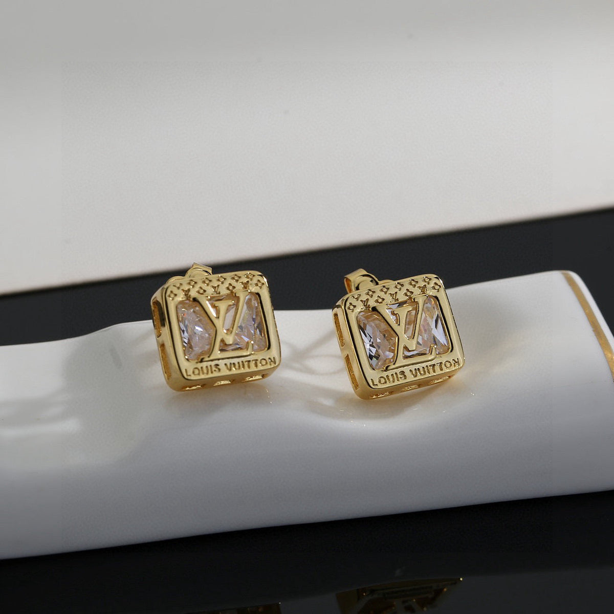 Martin Graham stud earrings in polished metal-tone – close-up detail