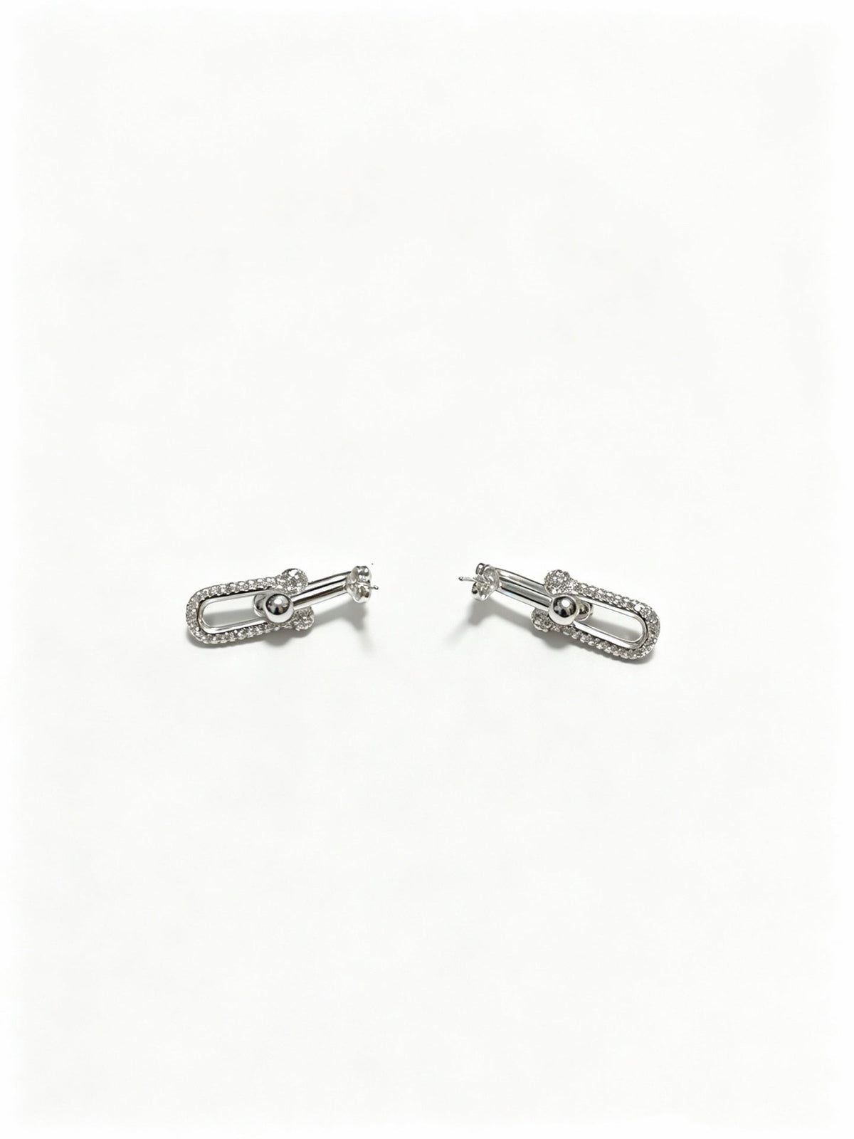 Martin Graham stud earrings in polished metal-tone – detail view