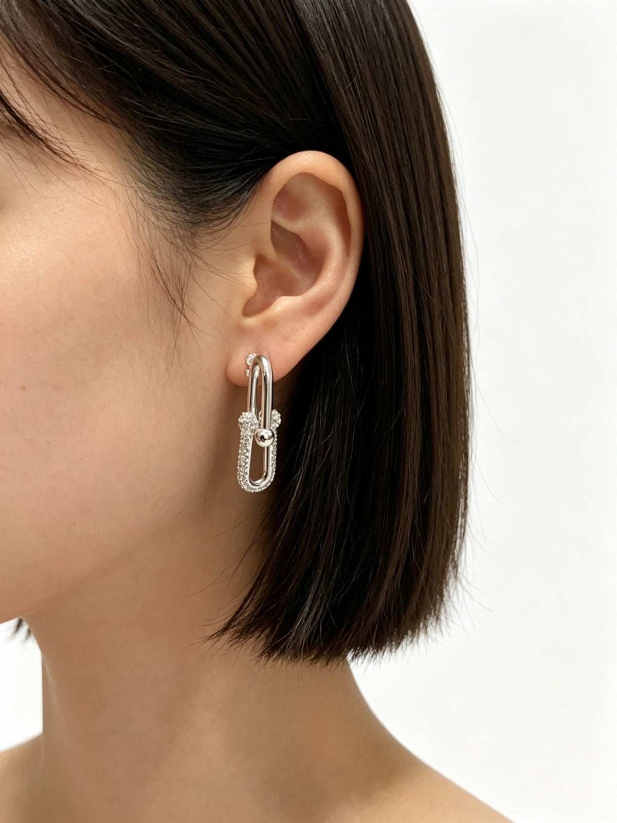 Martin Graham stud earrings in polished metal-tone – detail view