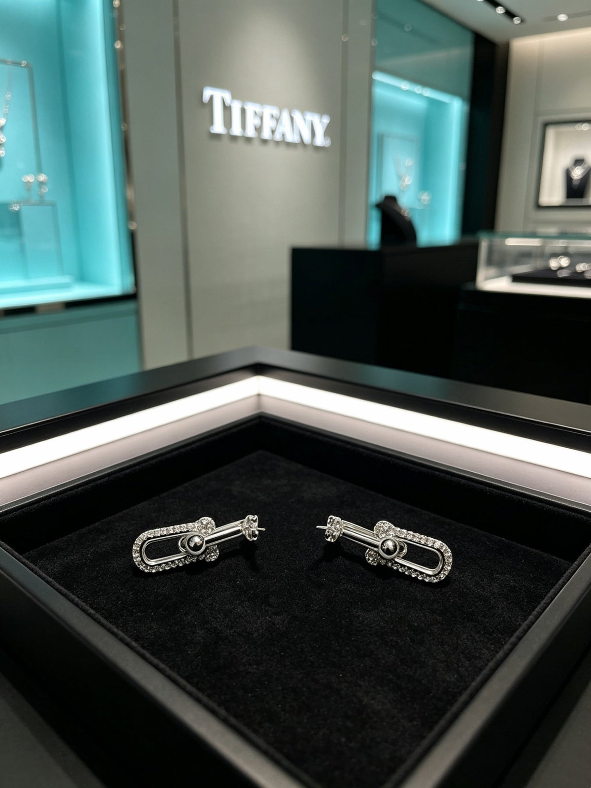 Martin Graham stud earrings in polished metal-tone – styled product view
