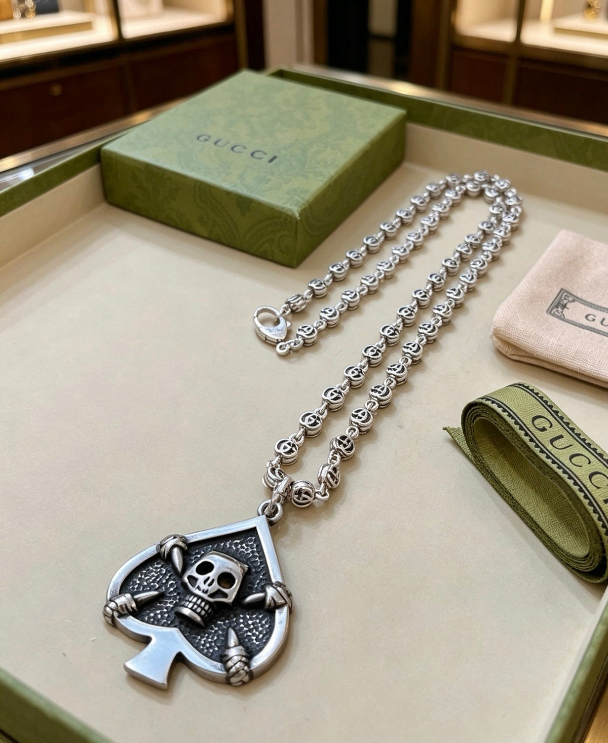 Martin Graham pendant necklace in polished metal-tone – detail view