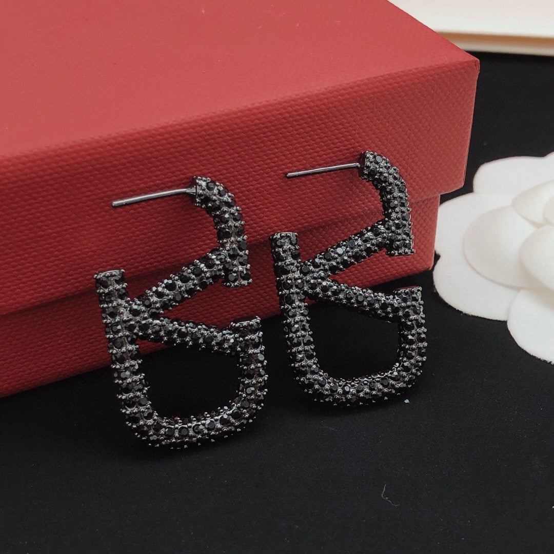 Martin Graham stud earrings in polished metal-tone