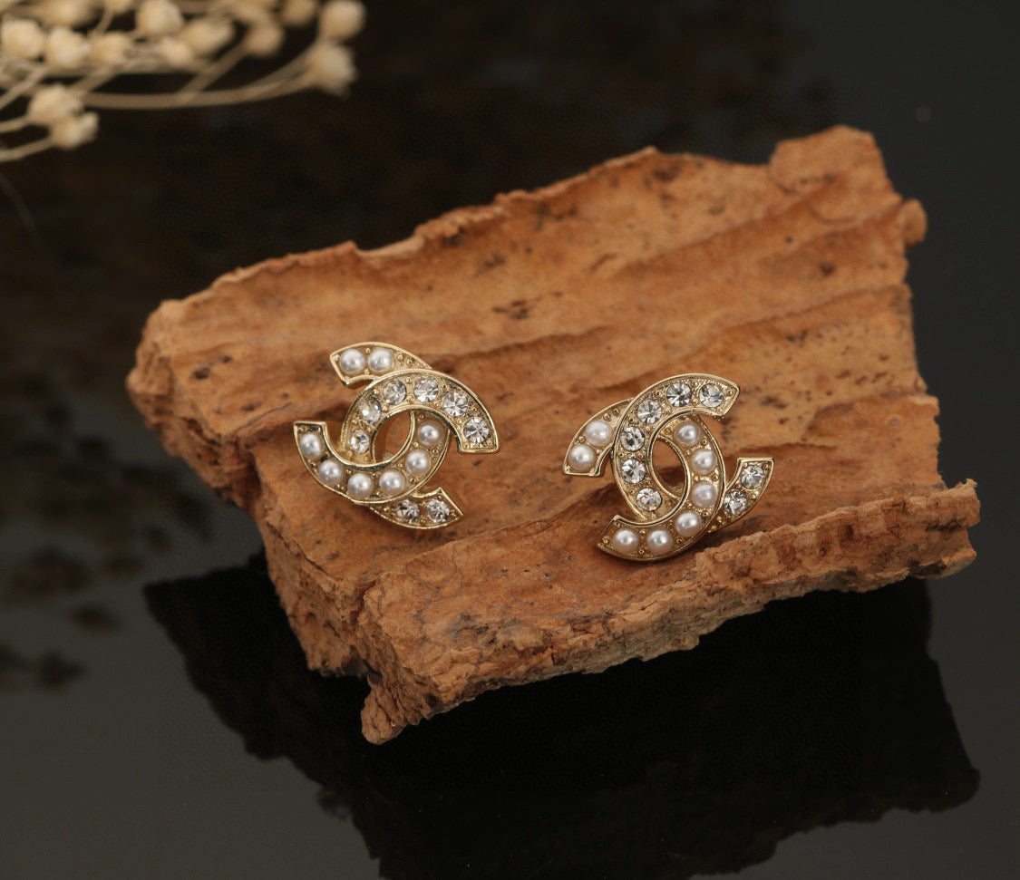 Martin Graham stud earrings in polished metal-tone – close-up detail