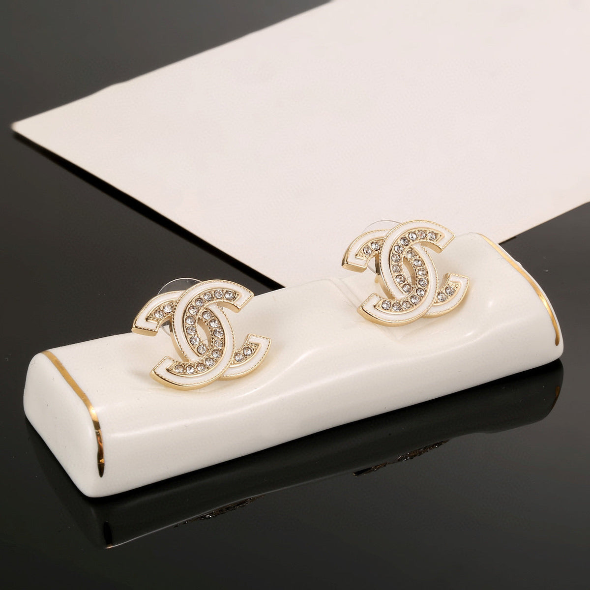 Martin Graham stud earrings in polished metal-tone – front product view