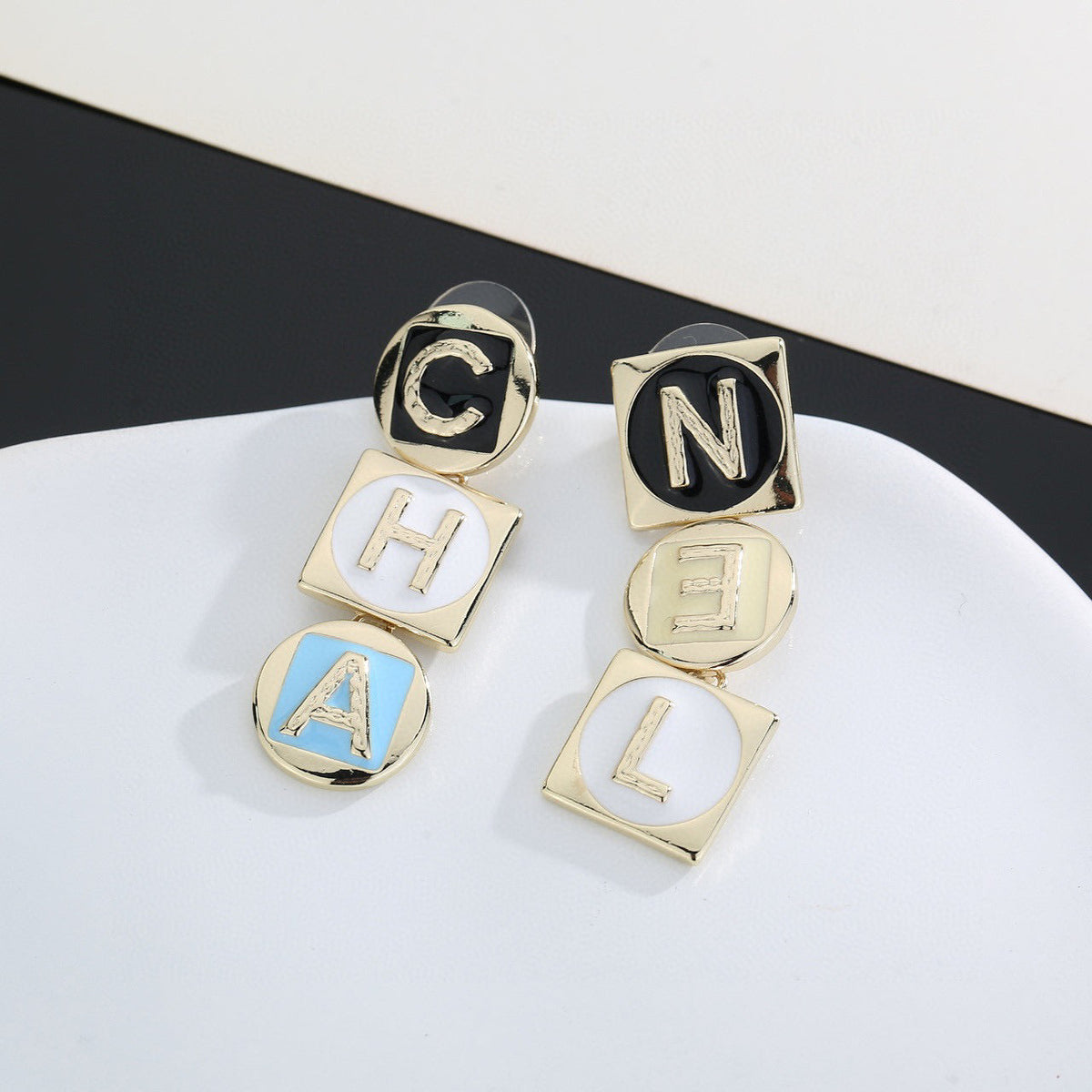 Martin Graham stud earrings in polished metal-tone – close-up detail