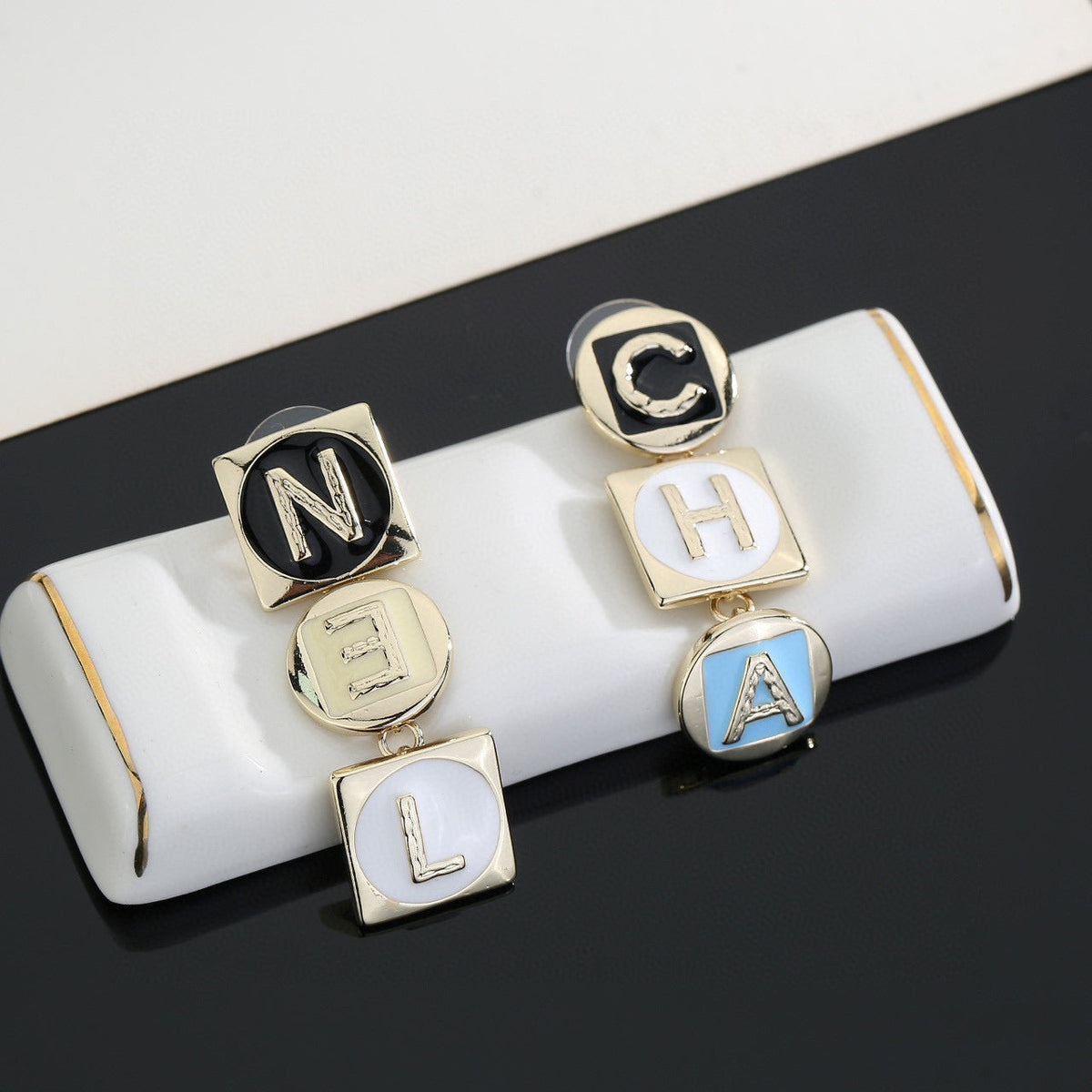 Martin Graham stud earrings in polished metal-tone – detail view