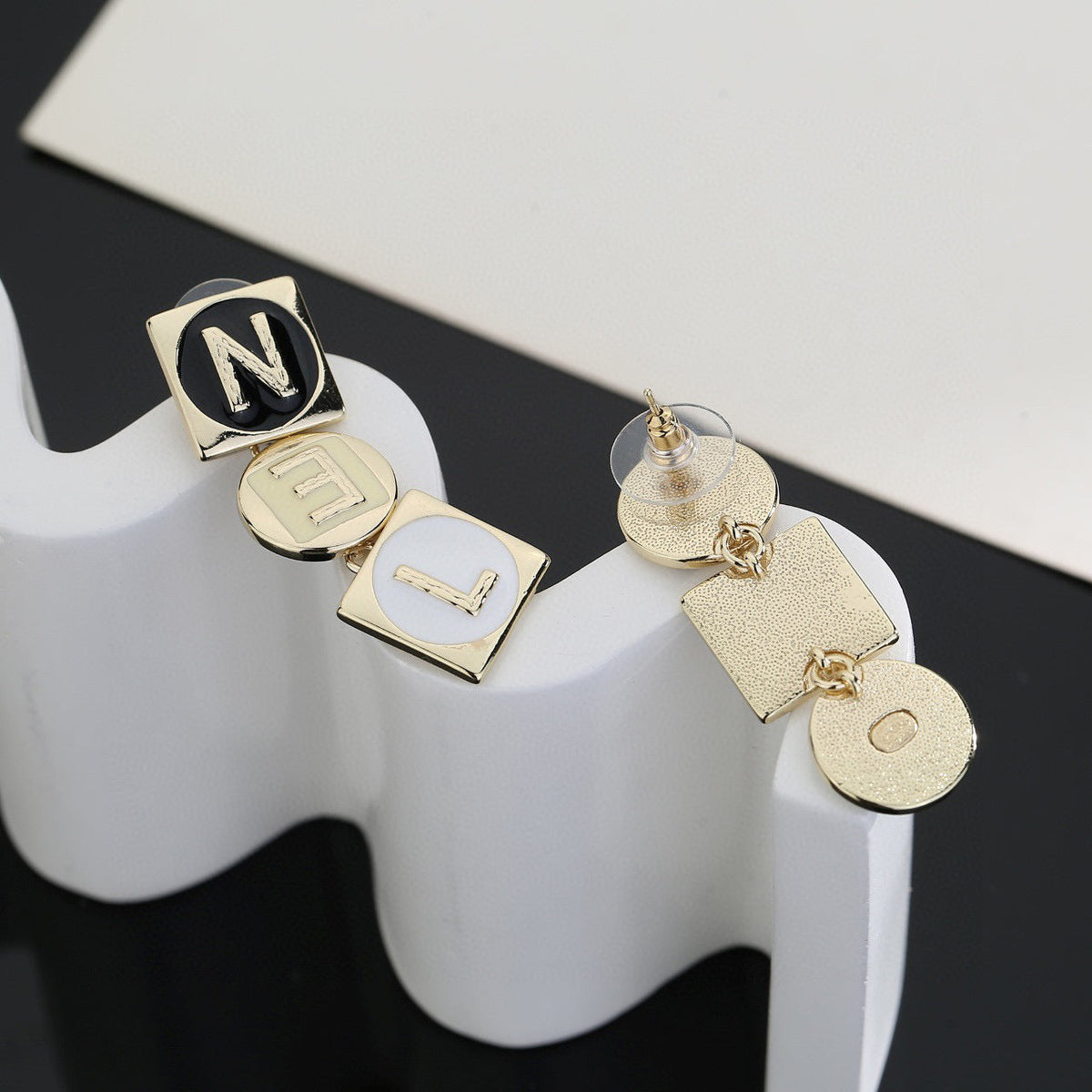 Martin Graham stud earrings in polished metal-tone – front product view