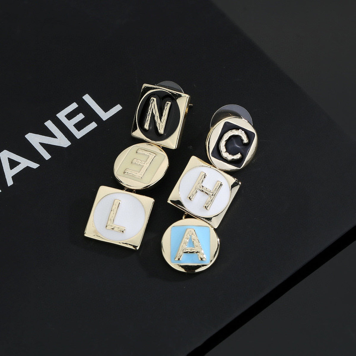 Martin Graham stud earrings in polished metal-tone – styled product view