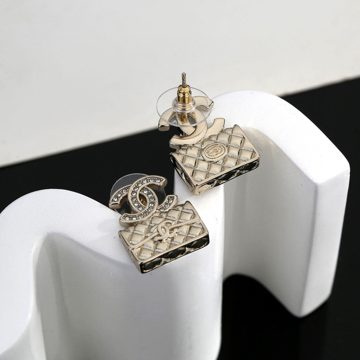 Martin Graham stud earrings in polished metal-tone – close-up detail