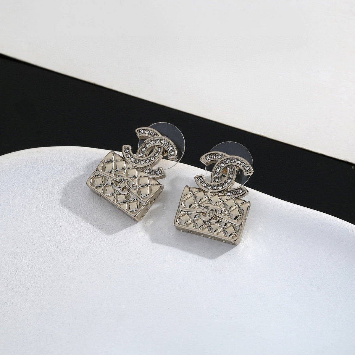 Martin Graham stud earrings in polished metal-tone – side detail