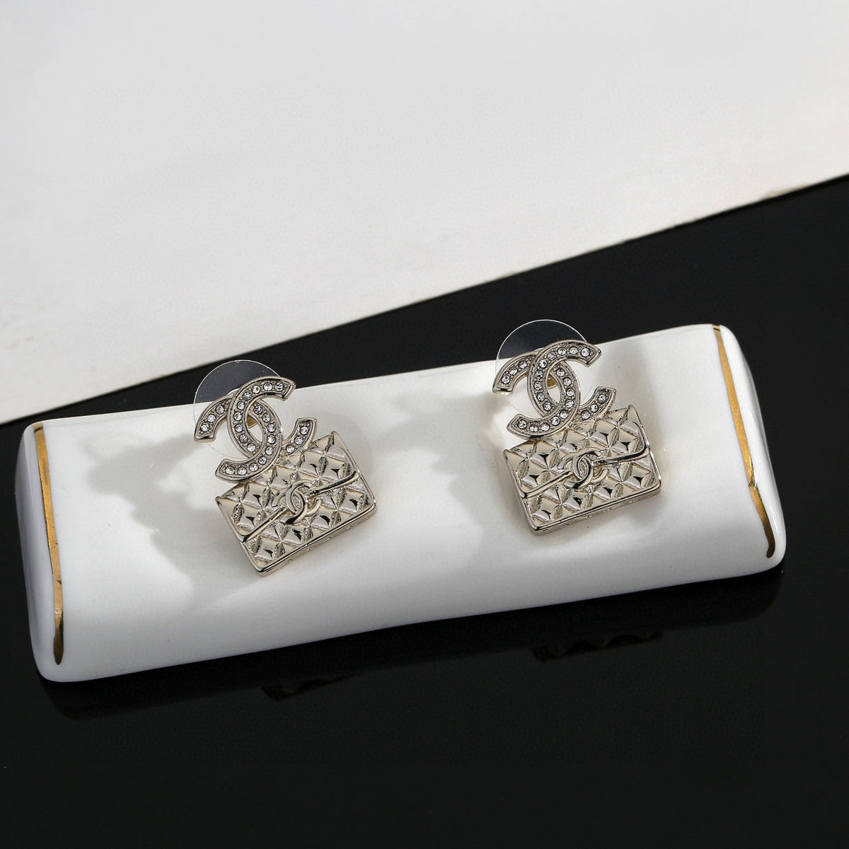 Martin Graham stud earrings in polished metal-tone – detail view