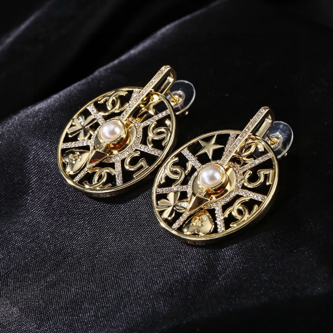 Martin Graham earrings in polished metal-tone – close-up detail