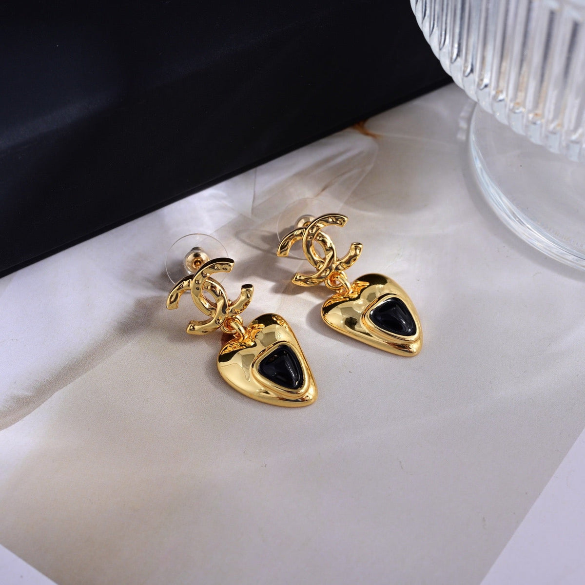 Martin Graham stud earrings in polished metal-tone – close-up detail