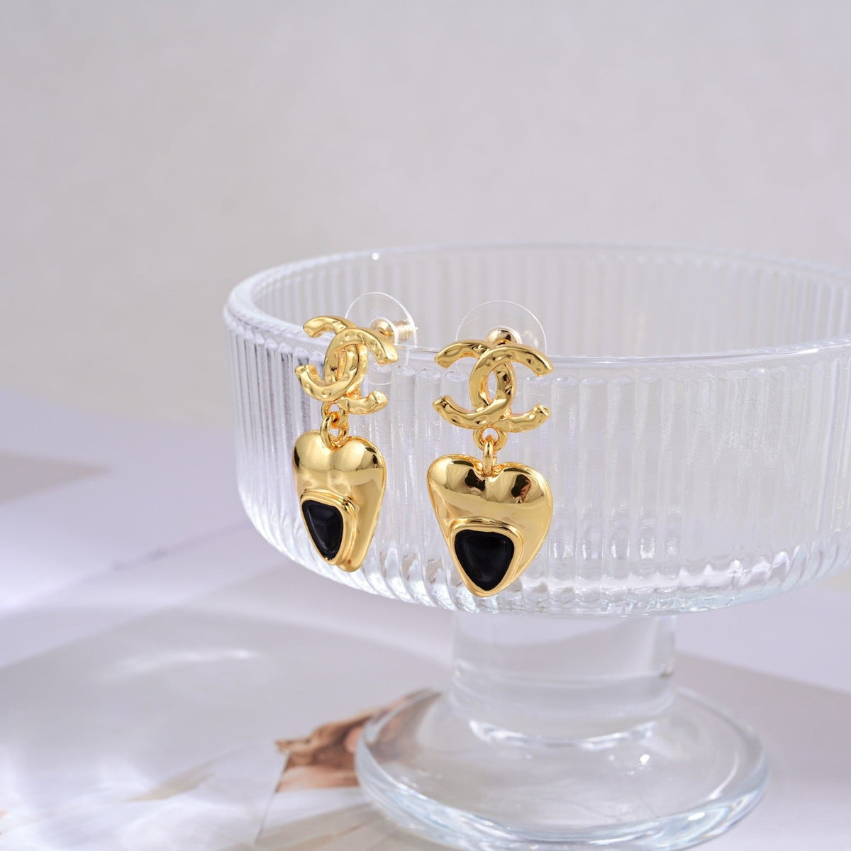 Martin Graham stud earrings in polished metal-tone – styled product view