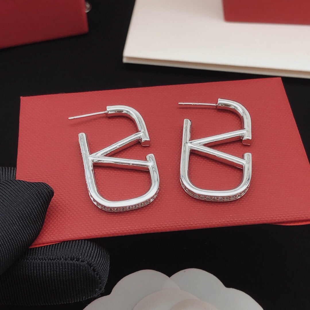 Martin Graham stud earrings in polished metal-tone