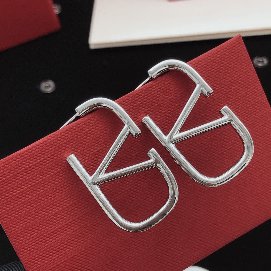 Martin Graham stud earrings in polished metal-tone – front view
