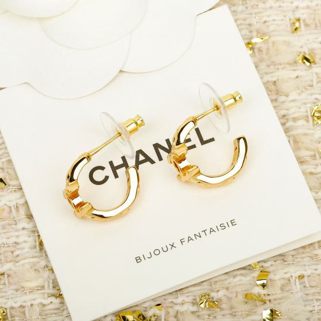 Martin Graham stud earrings in polished metal-tone – close-up detail