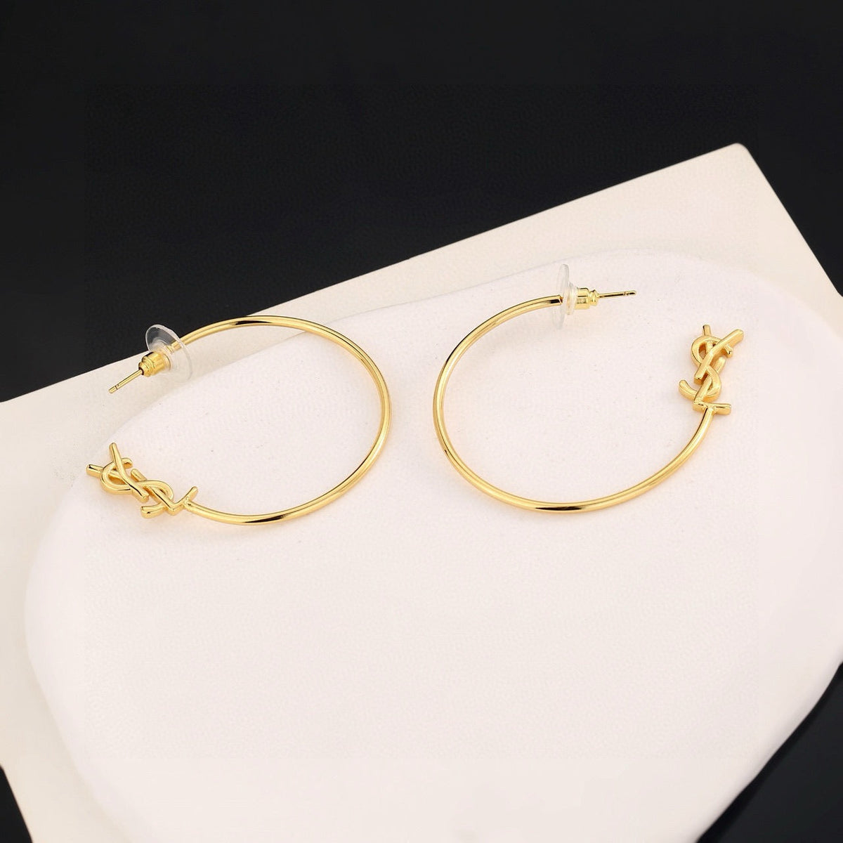 Martin Graham stud earrings in polished metal-tone – close-up detail