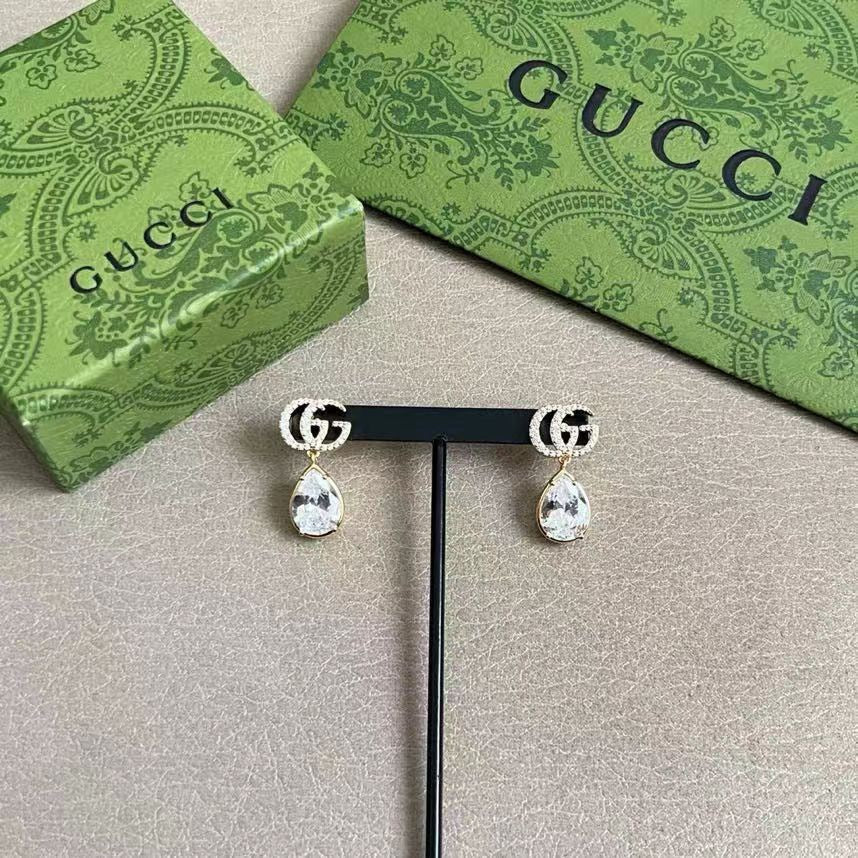 Martin Graham stud earrings in polished metal-tone – close-up detail