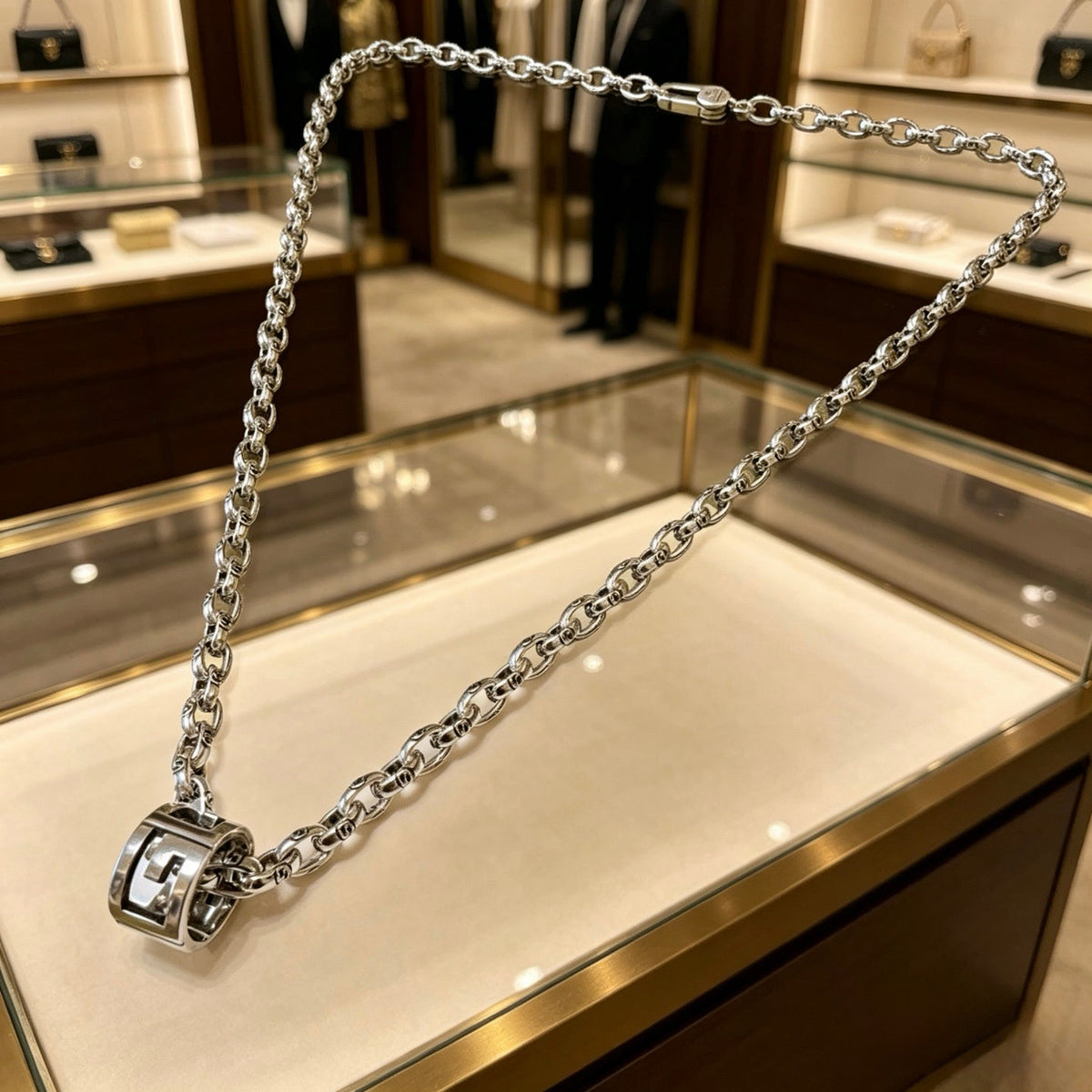 Martin Graham pendant necklace in polished metal-tone – close-up detail