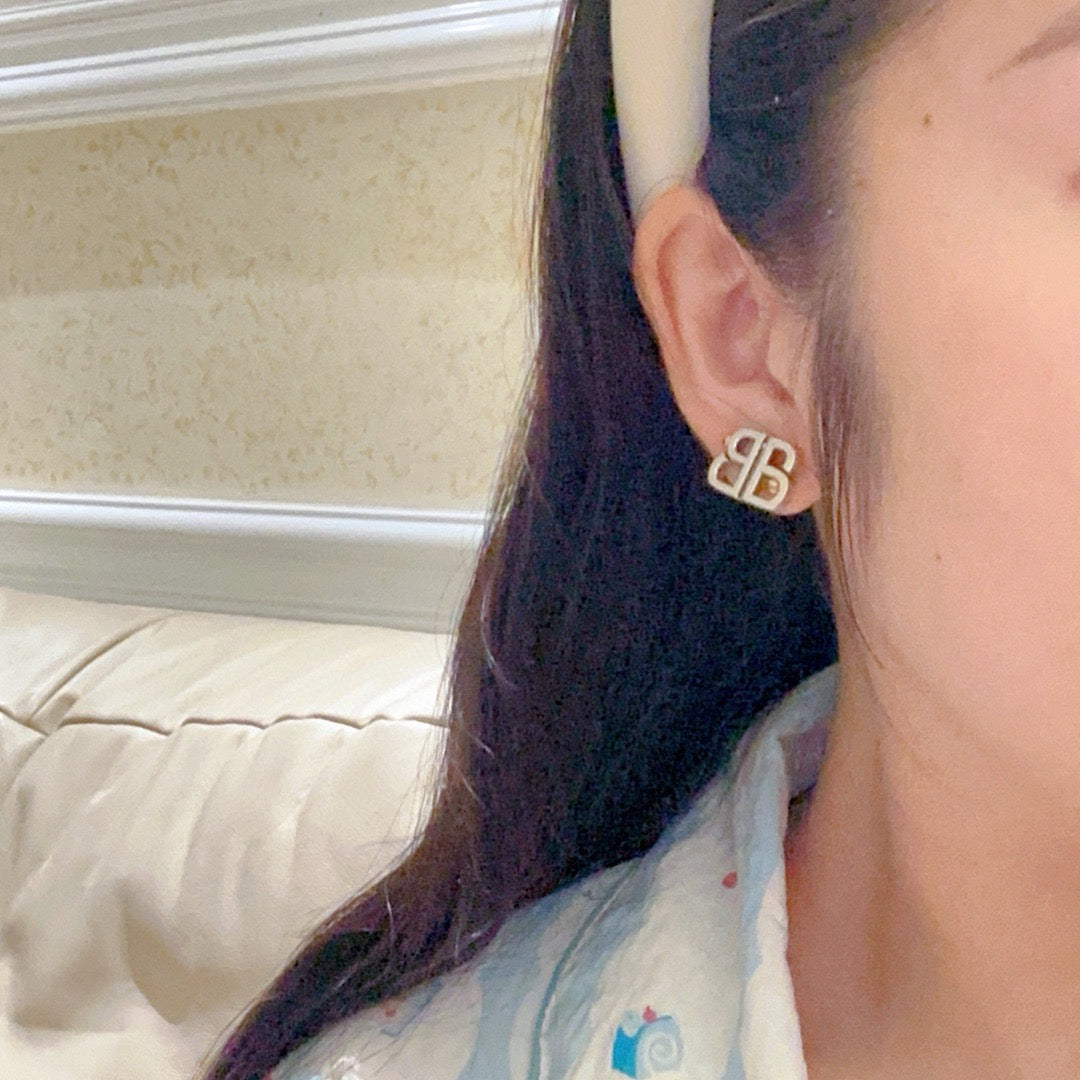 Martin Graham stud earrings in polished metal-tone – styled product view