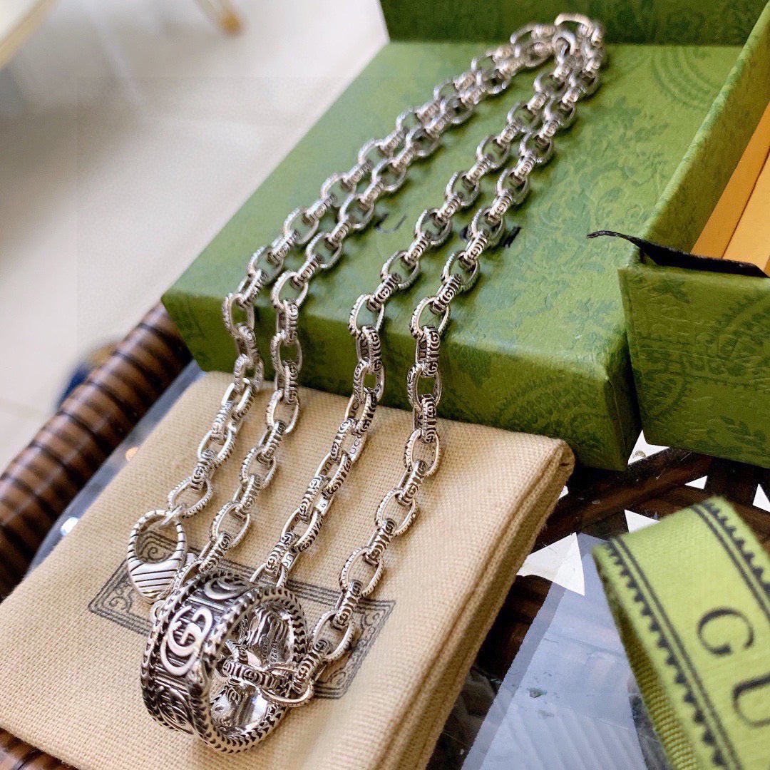 Martin Graham pendant necklace in polished metal-tone – side detail