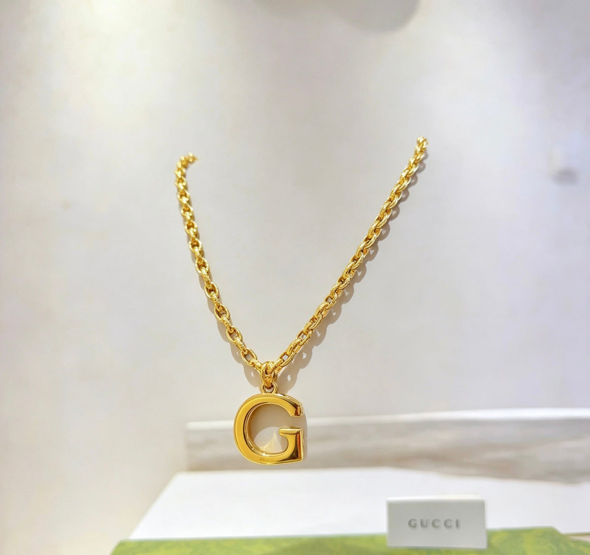 Martin Graham pendant necklace in polished metal-tone – close-up detail