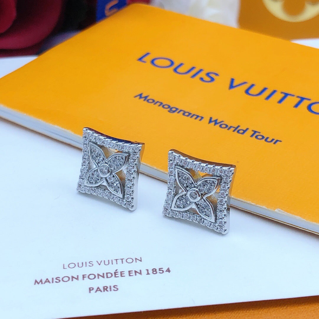 Martin Graham stud earrings in polished metal-tone – close-up detail